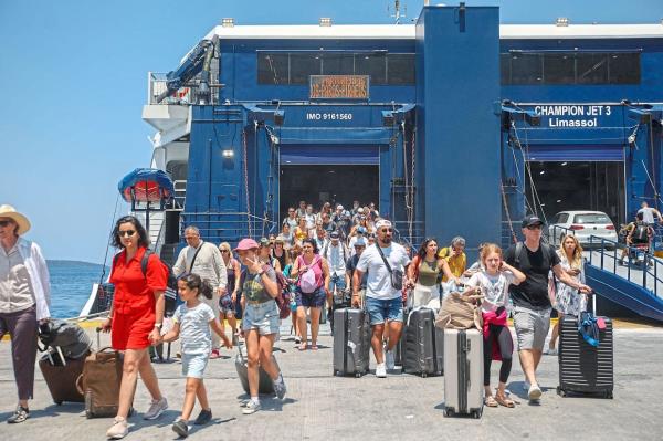 Tourists disembarking a ship at the island’s port. There is currently a cap of 8,000 cruise tourists a day on Santorini, which is a big number.